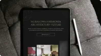 Tablet z prezentacją marki leży na szarej sofie obok białego rysika.