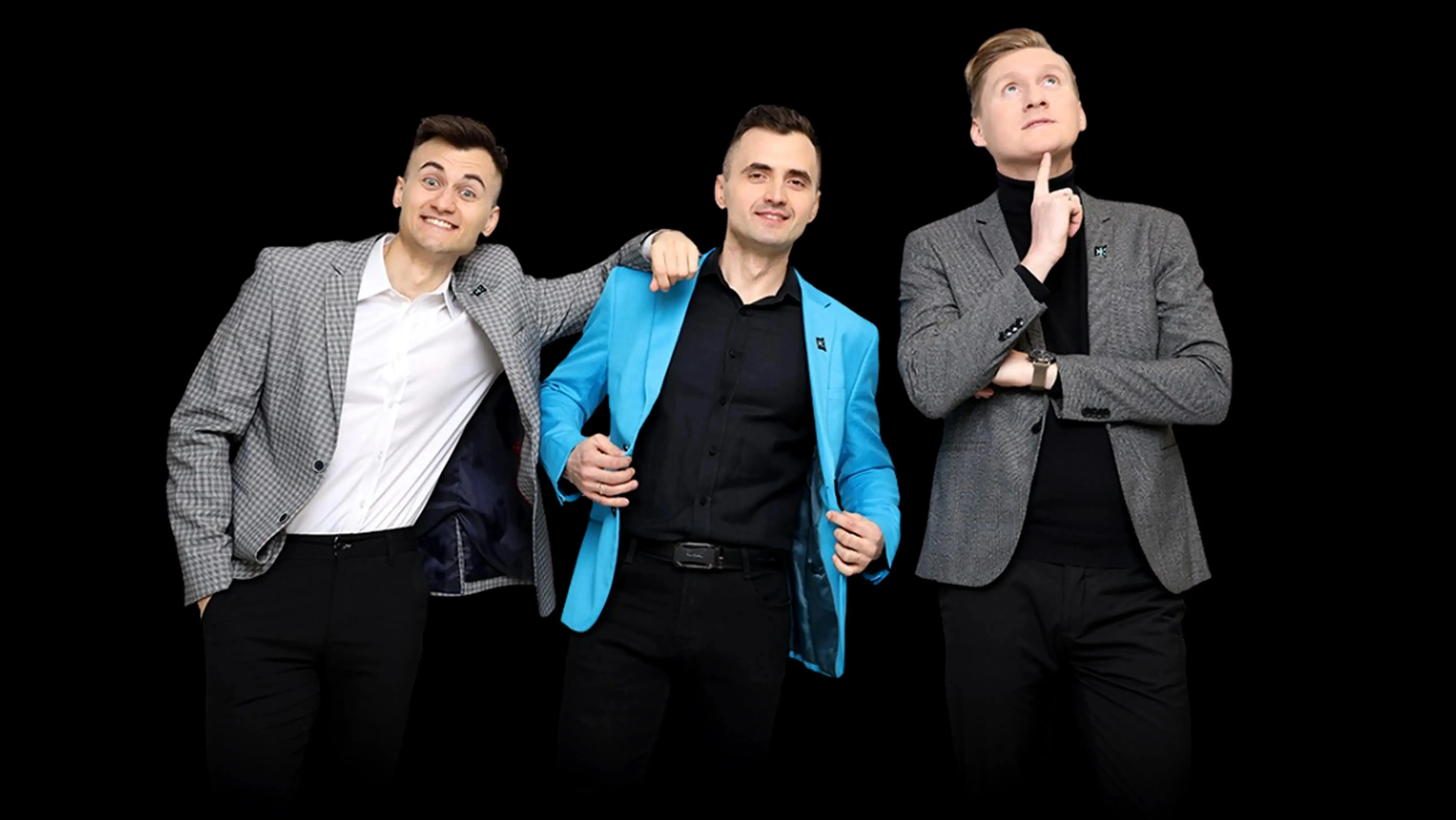 Michal in a blue blazer stands between two teammates in grey jackets; all pose confidently.