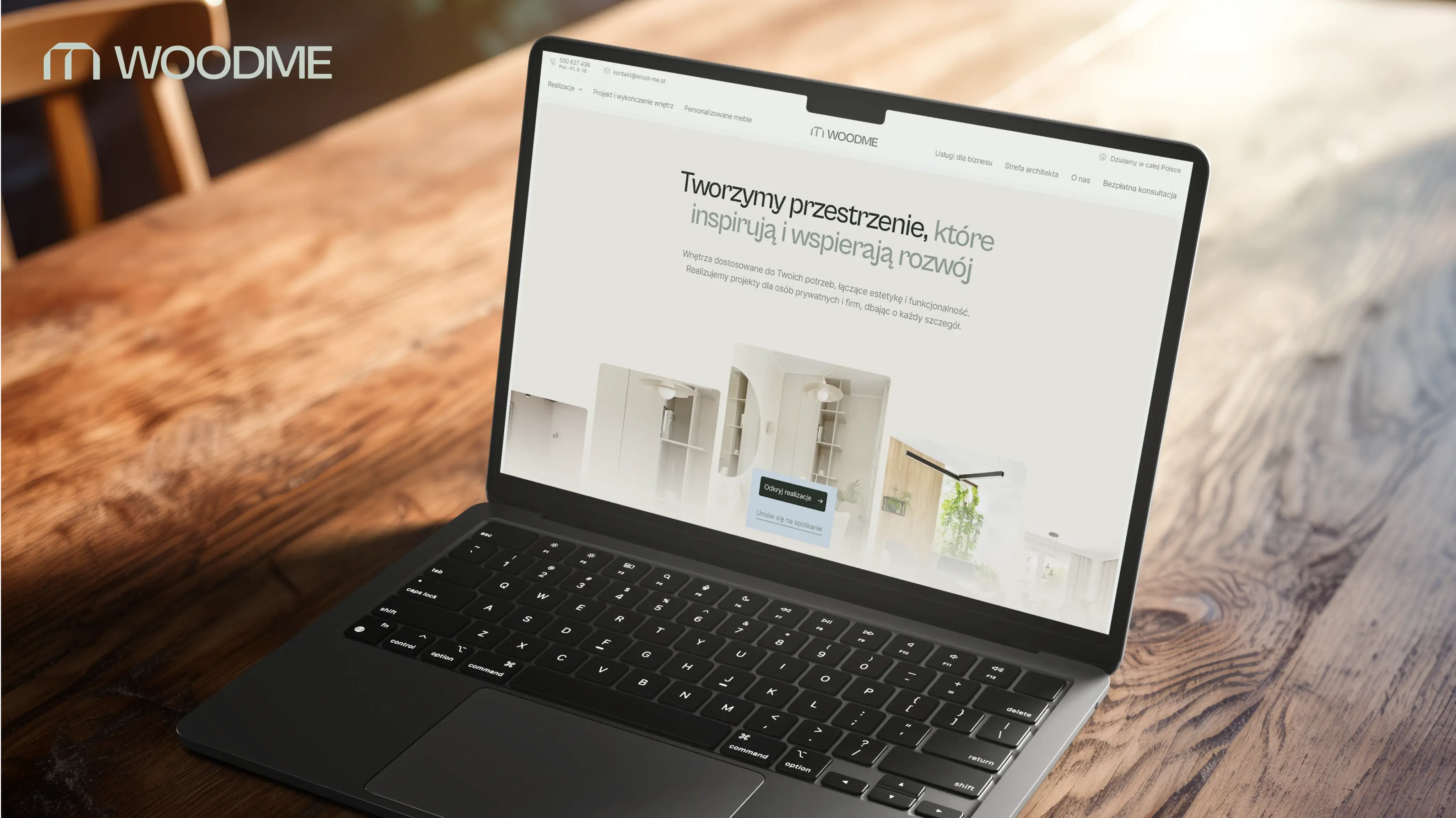 Laptop on a wooden desk shows the full-width WOODME webpage.