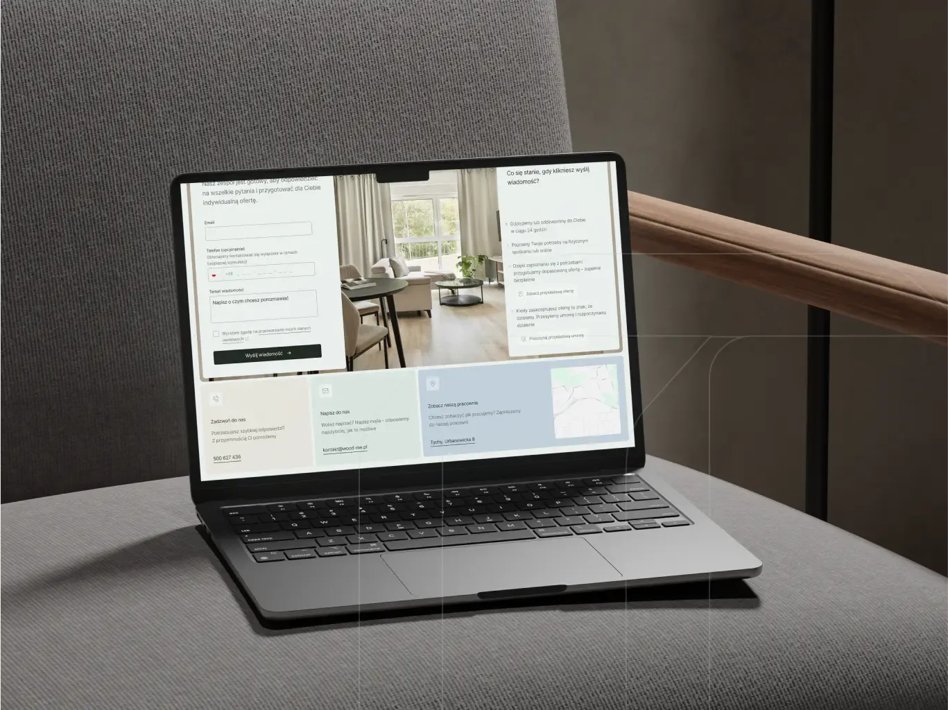 Black laptop on an upholstered chair displays the WOODME site with project description.