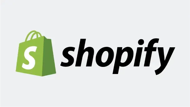 Zielona torba z literą „S” i czarny napis Shopify na białym tle.